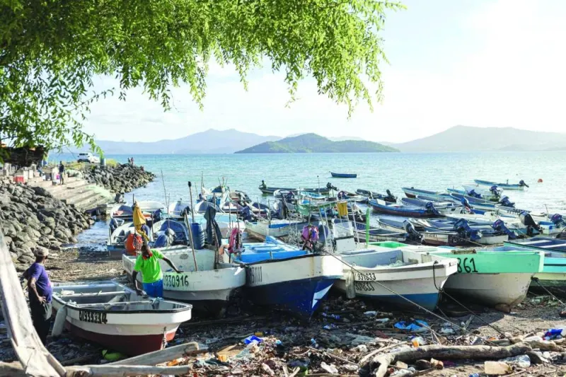 Fishermen work next to boats in Dzaoudzi, on the island of Mayotte.