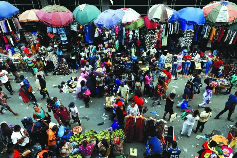File photo shows people crowd a market place as they shop in Lagos, Nigeria.