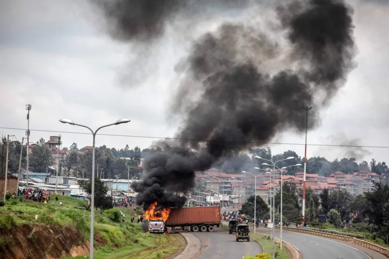 A lorry set on fire by protesters is seen during riots in the informal settlement of Kibera in Nairobi, yesterday.
