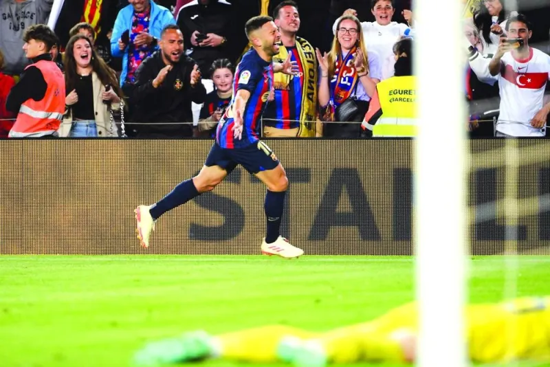 Barcelona’s Jordi Alba celebrates after scoring against Osasuna during the La Liga match in Barcelona on Tuesday. (AFP)