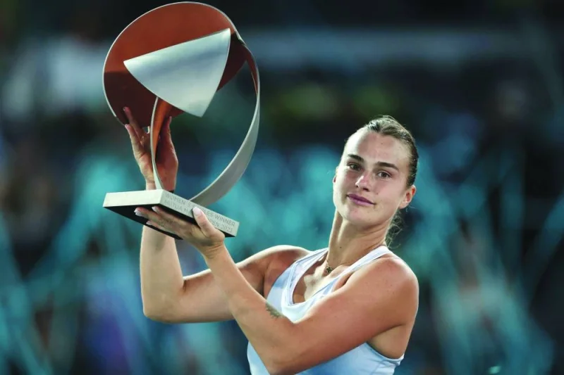 Belarus’ Aryna Sabalenka poses for pictures with the winner’s trophy after beating Poland’s Iga Swiatek in Madrid Open final on Saturday. (AFP)
