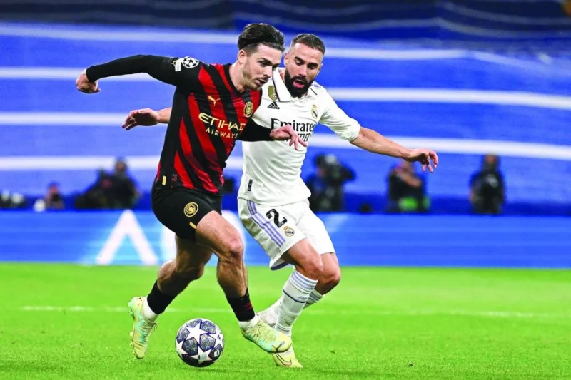 Manchester City’s Jack Grealish (left) vies for the ball with Real Madrid’s Dani Carvajal during the Champions League semi-final first leg at the Santiago Bernabeu Stadium. (AFP)
