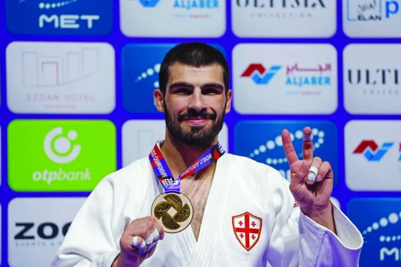 Georgia’s Tato Grigalashvili celebrates with his medal in Doha on Wednesday. (AFP)