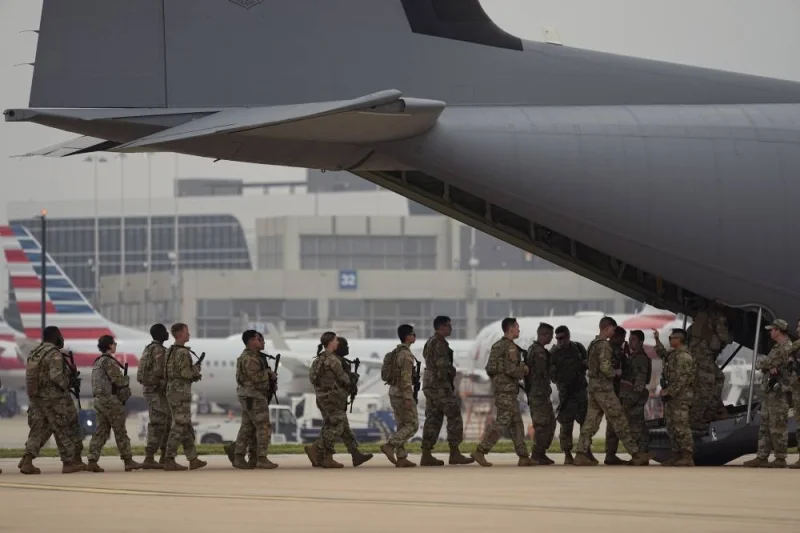 Members of the Texas National Guard board an aircraft as they prepare to deploy to the Texas-Mexico border in Austin, Texas, Monday, May 8, 2023. The Title 42 policy, a federal rule that has allowed the government to strictly regulate border entries, is set to expire this week. (AP Photo/Eric Gay)