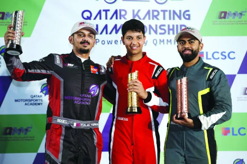 
Qatar Karting Championship winner Bader al-Sulaiti (centre), runner-up Faesal al-Yafei (left) and third-placed Omar Aswat pose with their trophies at the LCSC New Karting Track on Wednesday night. 