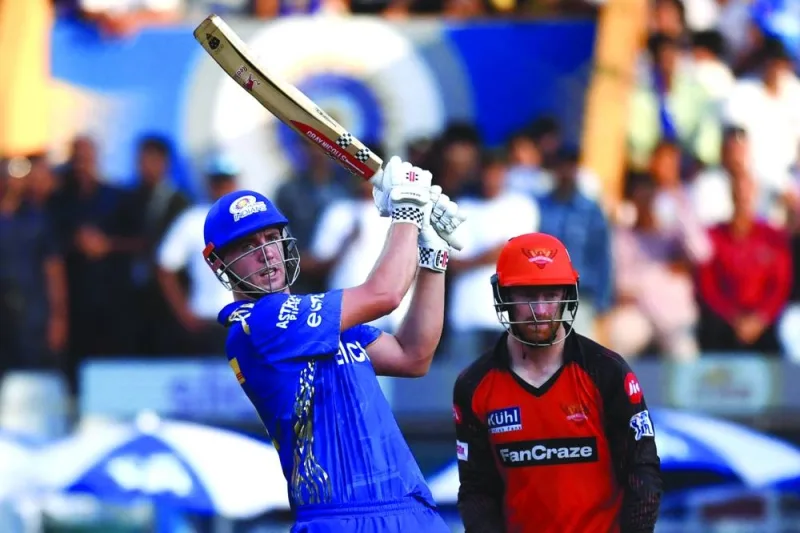 Mumbai Indians’ Cameron Green plays a shot as Sunrisers Hyderabad’s wicketkeeper Heinrich Klaasen watches during the IPL match at the Wankhede Stadium in Mumbai on Sunday. (AFP)