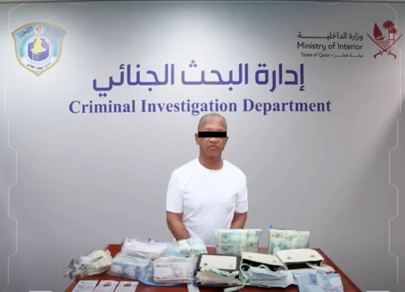 The arrested person with the money recovered from him.