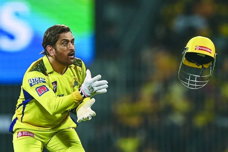 Chennai Super Kings’ Mahendra Singh Dhoni catches a helmet during the IPL first qualifier against defending champions Gujarat Titans in Chennai on Tuesday. (AFP)