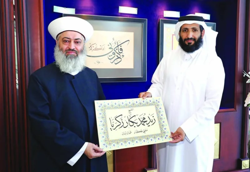 Mufti of Akkar in the north of the Lebanon Sheikh Zaid Mohamed Bakkar Zakaria is honoured by Fanar Director Dr Saleh bin Ali al-Marri.
