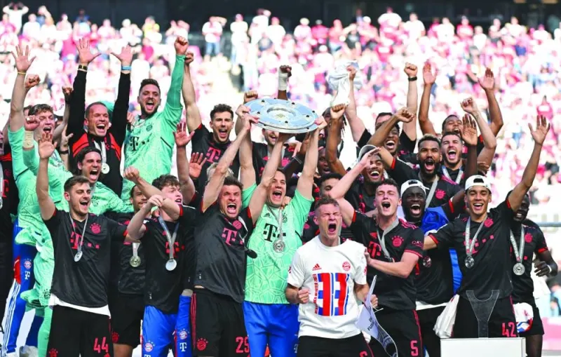 Bayern Munich players celebrate with the trophy after winning the Bundesliga title in Cologne, Germany, on Saturday. (Reuters)