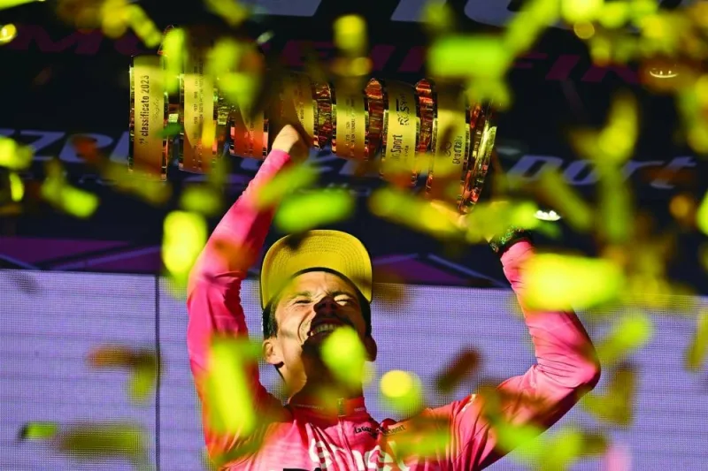 Jumbo-Visma’s Slovenian rider Primoz Roglic celebrates on the podium with the race’s winner’s “Trofeo Senza Fine” (Endless Trophy) after clinching the Giro d’Italia 2023 cycling race in Rome on Sunday. (AFP)