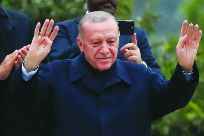 Turkish President Tayyip Erdogan gestures as he addresses his supporters following early exit poll results for the second round of the presidential election in Istanbul on Sunday.  (Reuters)