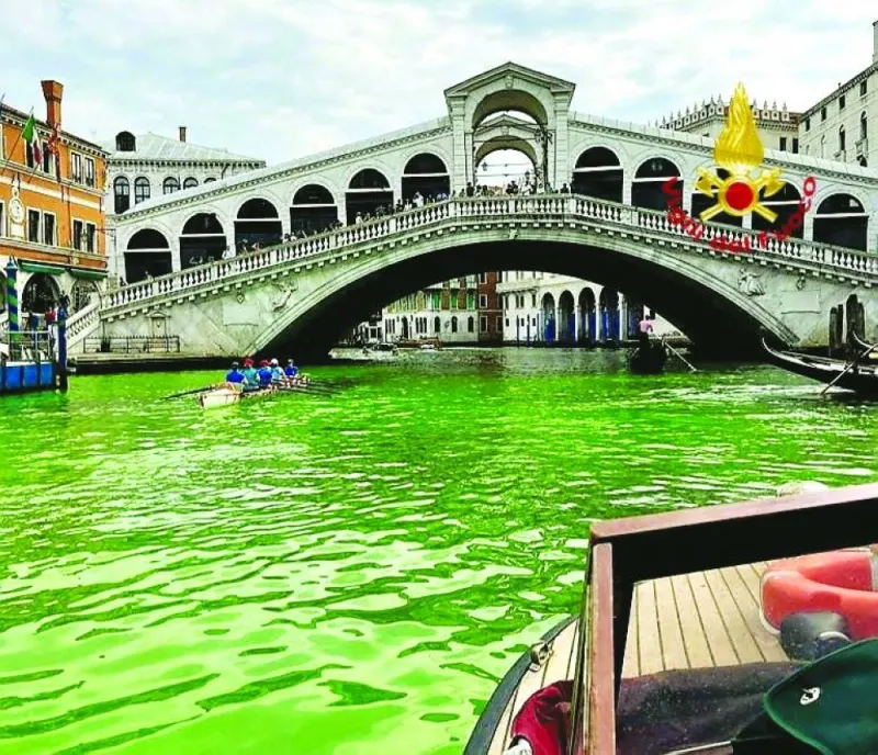 Venice’s waters turn green due to an unknown substance near the Rialto Bridge in Venice on Sunday. (Reuters)
