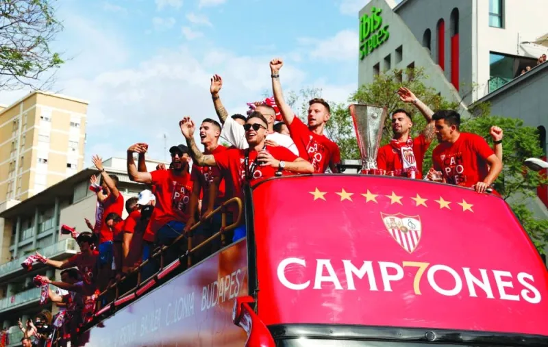 
Sevilla players celebrate on the team bus yesterday in Seville after winning the Europa League. (Reuters) 