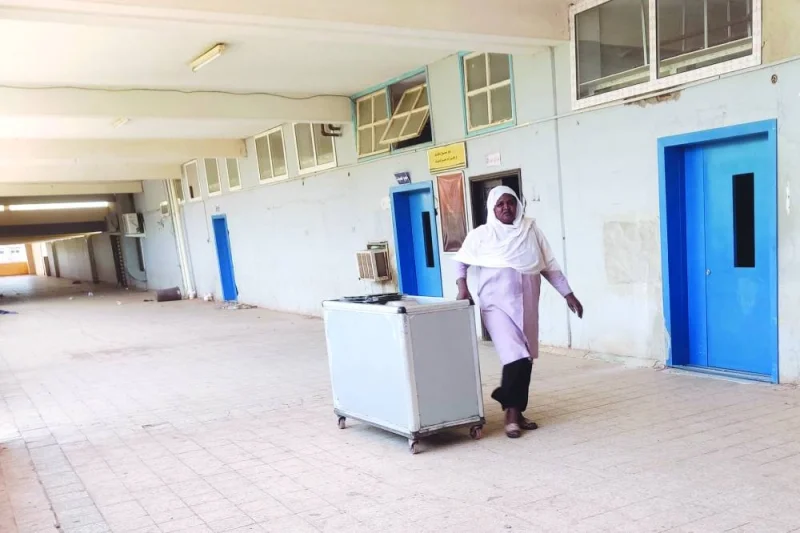 
A medic walks in an empty hallway at Soba University Hospital in southern Khartoum, yesterday, where only the dialysis department remains open. 