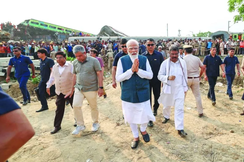 
This handout photograph released by the Indian Press Information Bureau (PIB) shows Prime Minister Narendra Modi visiting the accident site. 