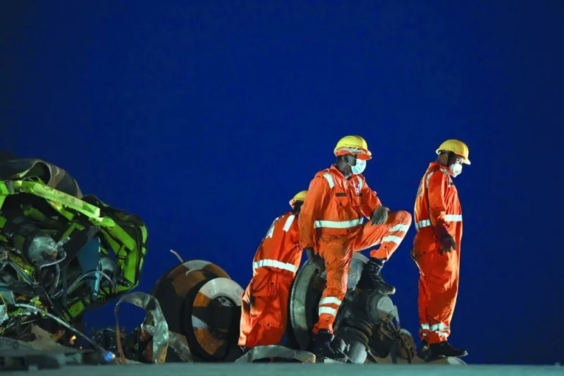 Rescue workers work to recover bodies from the carriage wreckage of a three-train collision near Balasore.