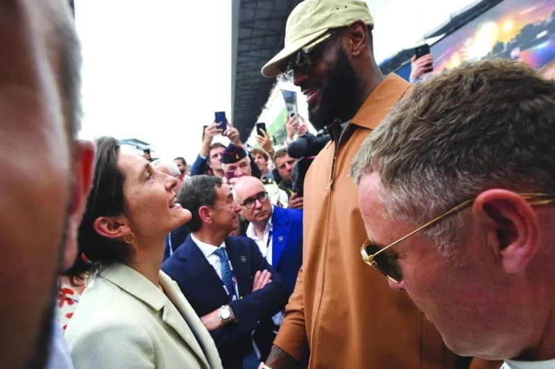 French Sports Minister Amelie Oudea-Castera greets Los Angeles Lakers star LeBron James before the start of the 100th edition of the 24 Hours of Le Mans on Saturday. (AFP)