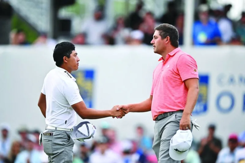 
Pan Cheng-tsung of Chinese Taipei shakes hands with Andrew Novak of the United States on the 18th hole after the third round of the RBC Canadian Open at Oakdale Golf & Country Club in Toronto, Ontario. (AFP) 
