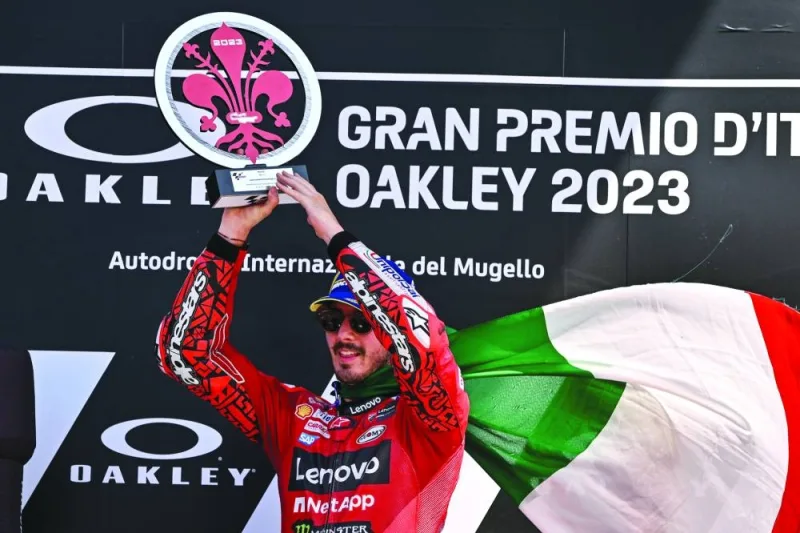 Ducati Italian rider Francesco Bagnaia celebrates with the trophy after winning the Italian Grand Prix at Mugello Circuit on Sunday. (AFP)