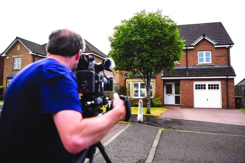 
A journalist films the home of Peter Murrell, former chief executive of the Scottish National Party (SNP), and his wife, former Scotland first minister and former SNP leader Nicola Sturgeon (pictured right), in Glasgow. 