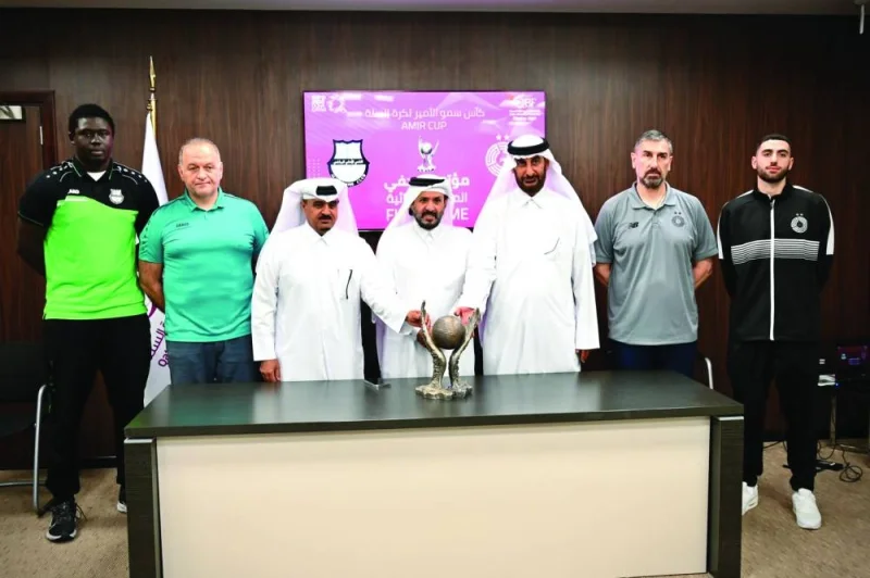 QBF Secretary-General Saadoun Sabah al-Kuwari (centre) poses with Amir Cup basketball trophy along with coaches, players and other officials on Wednesday.