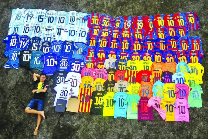This aerial photo shows, Surya Wijaya Ang, a Lionel Messi fan posing for a selfie next to his collection of football jerseys adorned with Argentine legends name in Banda Neira, Indonesian. Indonesian fans of Messi expressed dismay on Friday after the football star pulled out of a friendly match. (AFP)