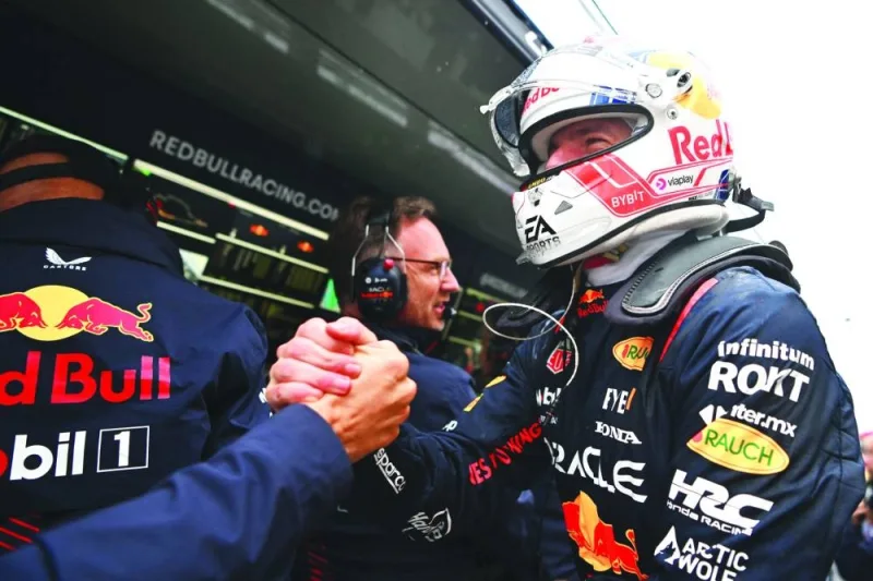 Pole position qualifier Max Verstappen of Red Bull Racing celebrates with his team in the pitlane at Circuit Gilles Villeneuve in Montreal on Saturday. (AFP)