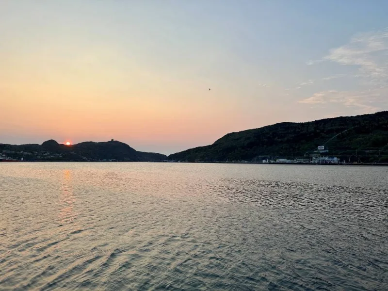 The sun rises as the search for the missing OceanGate Expeditions submersible, which is carrying five people to explore the wreck of the sunken Titanic, enters its final hours, over St. John’s Harbour, Newfoundland and Labrador, Canada, June 22, 2023. REUTERS/Eric Cox