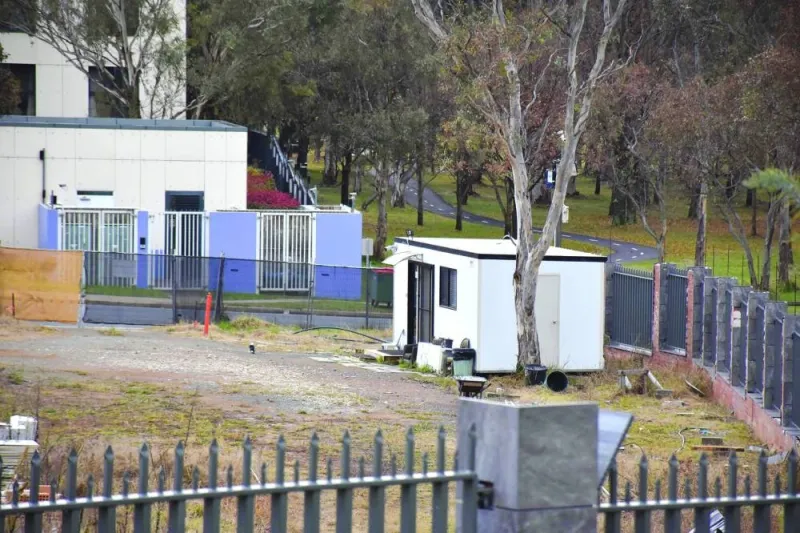 A portable security shed surrounded by weeds and discarded building materials is seen on a vacant land, which is a proposed new Russian embassy site, in Canberra, Australia, on Friday.
