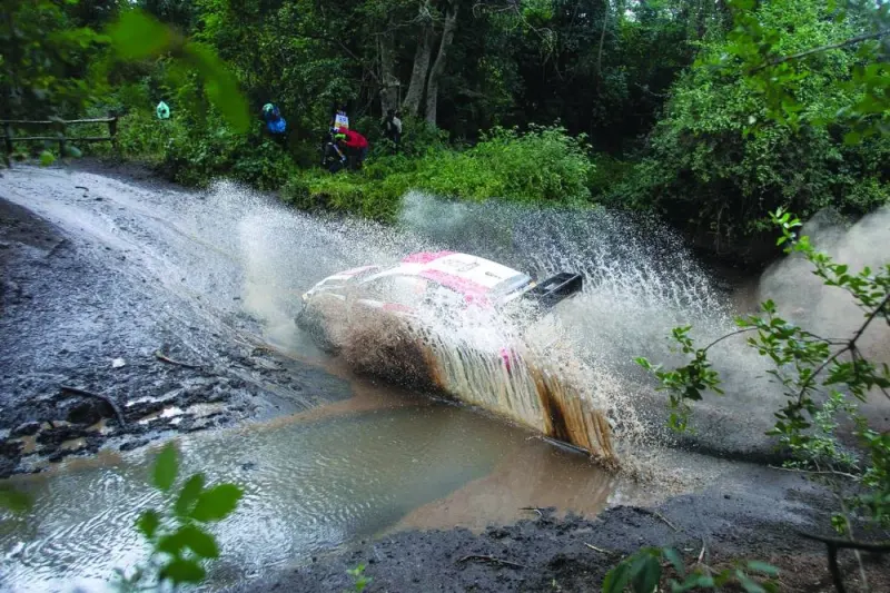 Kalle Rovanpera and co-driver Jonne Halttunen manoeuvre their Toyota GR Yaris Rally1 hybrid across a stream during the third day of Safari Rally in Naivasha, Kenya, on Saturday. (AFP)