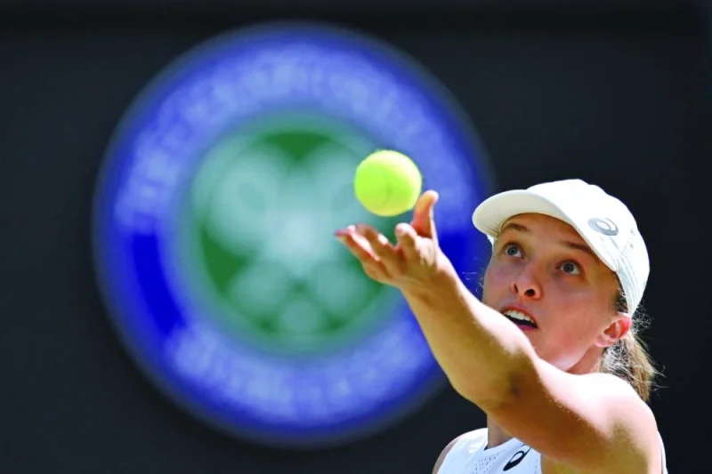 
Poland’s Iga Swiatek serves to France’s Alize Cornet during their singles match on the sixth day of the 2022 Wimbledon Championships at The All England Tennis Club in Wimbledon, southwest London, on July 2, 2022. (AFP) 