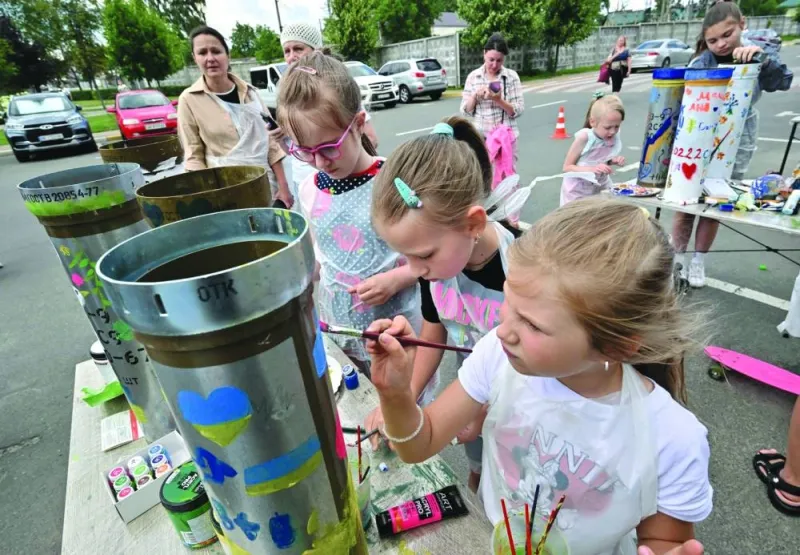 
Children paint shell casings for the local ‘Museum of Memory’ during an art event in Bucha, north of Kyiv. 