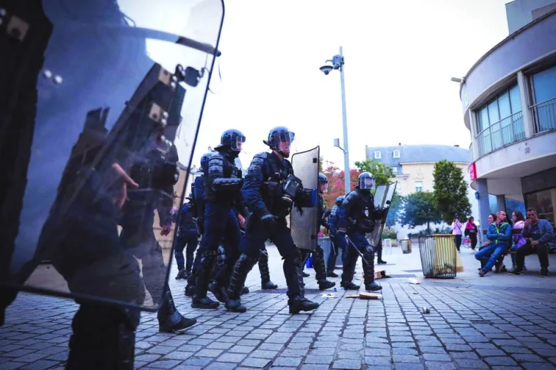 French riot police officers patrol during a demonstration in Caen, north-western France.