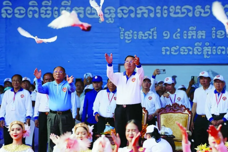 Cambodia’s Prime Minister Hun Sen and Heng Samrin, president of the National Assembly, release pigeons during an election campaign for the upcoming national election in Phnom Penh, Cambodia, on Saturday.