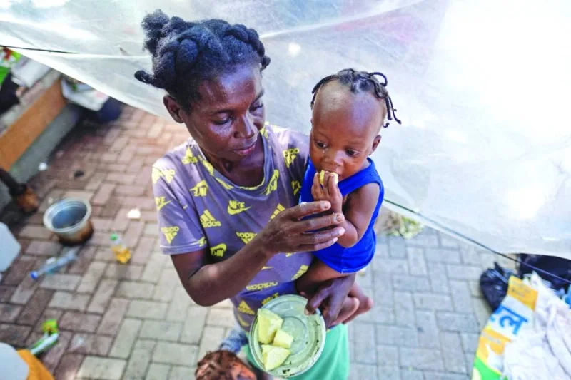 
This picture taken in October last year shows a woman feeding her baby at the Port-au-Prince’s Hugo Chavez Square where they sought shelter from gang war violence. 