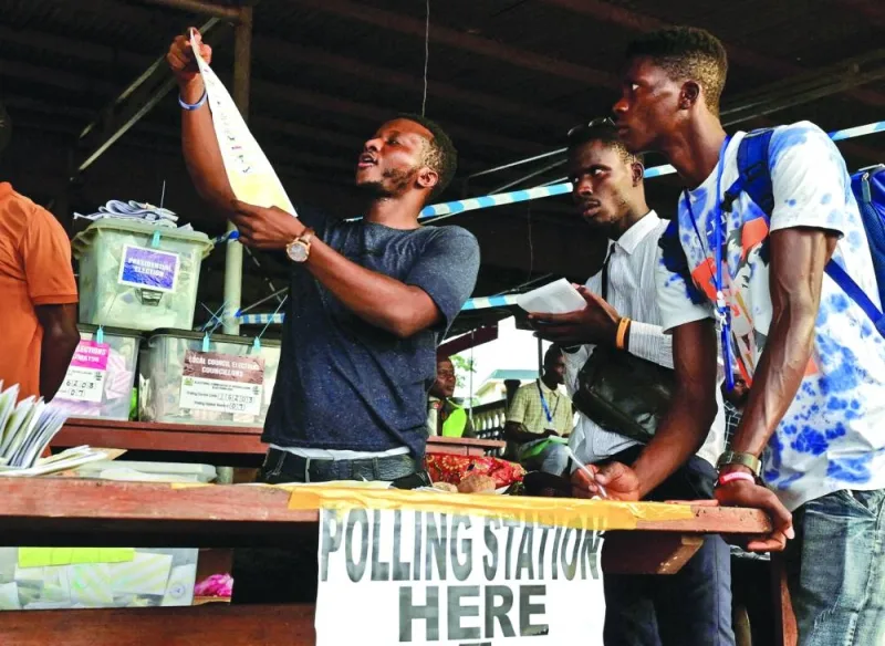 
File photo shows election workers counting ballots at a polling station, on the day of the national election, in Freetown, Sierra Leone, on June 24. 