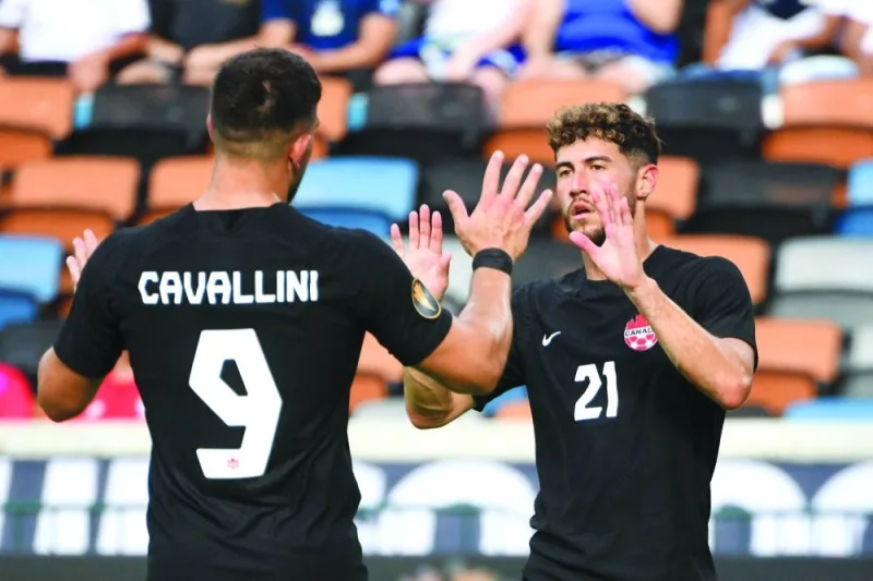 Canada’s Jonathan Osorio (right) celebrates scoring goal with teammate Lucas Cavallini during the CONCACAF Gold Cup Group ‘D’ match against Cuba at Shell Energy Stadium in Houston. (AFP)