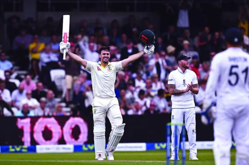 Australia’s Mitchell Marsh celebrates reaching his hundred on day one of the third Ashes Test against England at Headingley, Leeds, northern England, yesterday. Right: England’s Mark Wood (second right) celebrates after taking the wicket of Australia’s Usman Khawaja on day one of the third Ashes Test on Thursday. (Reuters/AFP)