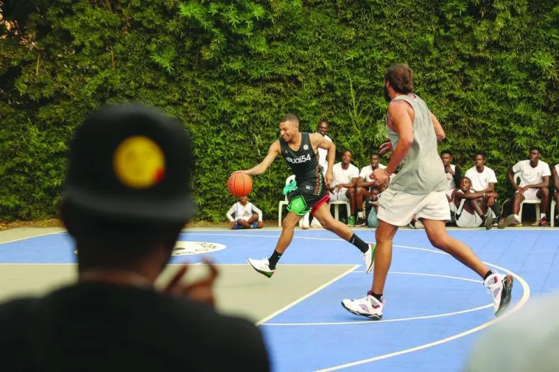 
Paris Saint-Germain and France striker Kylian Mbappe (left) plays basketball with former professional basketball player Joakim Noah at the Club Noah sports complex in Yaounde, Cameroon. (AFP) 