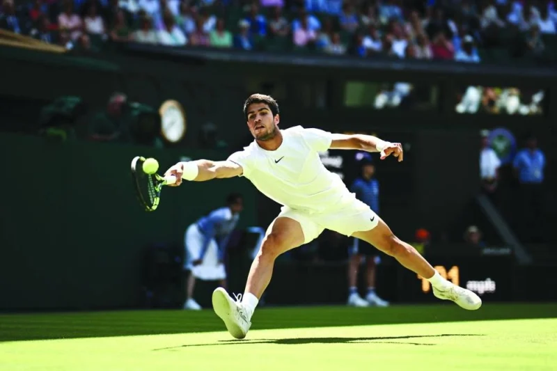 Spain’s Carlos Alcaraz returns the ball to France’s Alexandre Muller during their second round match on the fifth day of the 2023 Wimbledon Championships at The All England Tennis Club in Wimbledon, southwest London, on Friday. (AFP)
