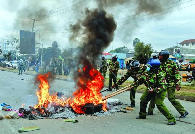 
Riot police officers remove a barricade after dispersing supporters of Kenya’s opposition leader Raila Odinga of the Azimio La Umoja (Declaration of Unity) One Kenya Alliance, during an anti-government protest dubbed “Saba Saba (7th of July) People’s March”, in Nairobi, yesterday. 