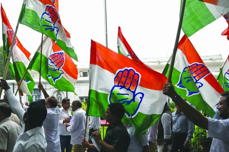 
Congress leader Rahul Gandhi’s supporters wave Congress party flags at All India Congress Committee headquarters in New Delhi. 
