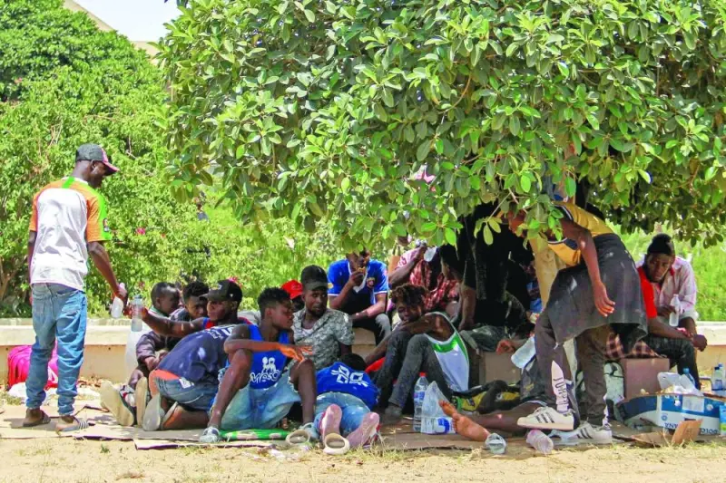 Sub-Saharan migrants rest under the shade of a tree to avoid the heat during a protest against the dire conditions of migrants in Tunisia’s coastal central city of Sfax, on Friday.