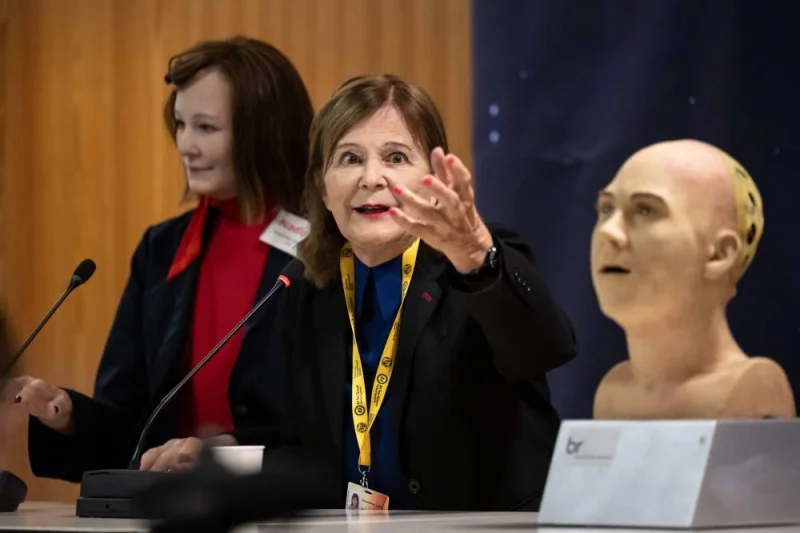 Professor Nadia Magnenat Thalmann (C) gestures next to AI-powered humanoid social robot "Nadine" (L) during what was presented as the World&#039;s first press conference with a panel of AI-enabled humanoid social robots as part of International Telecommunication Union (ITU) AI for Good Global Summit in Geneva. Fabrice COFFRINI / AFP