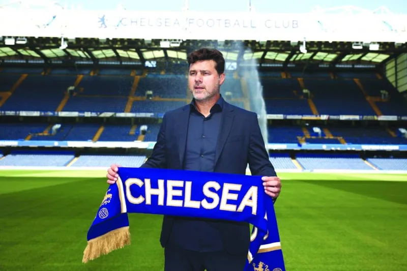 Chelsea’s Argentinian head coach Mauricio Pochettino poses with a Chelsea scarf beside the pitch at Stamford Bridge in London on Saturday, as he is introduced to the media as the new Chelsea Head Coach. (AFP)