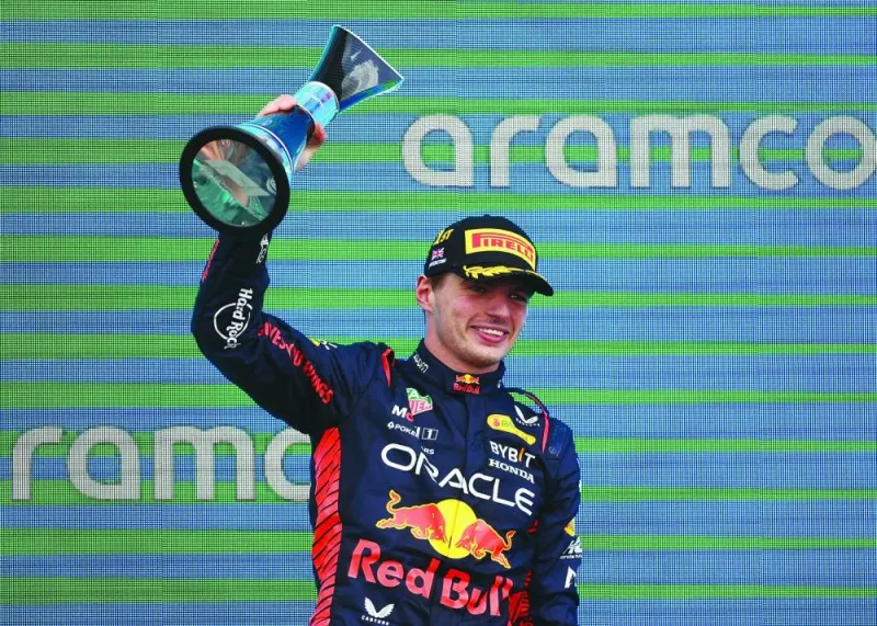 
Red Bull’s Max Verstappen celebrates with a trophy on the podium after winning the the British Grand Prix at Silverstone Circuit, Silverstone, Britain, yesterday. (Reuters) 