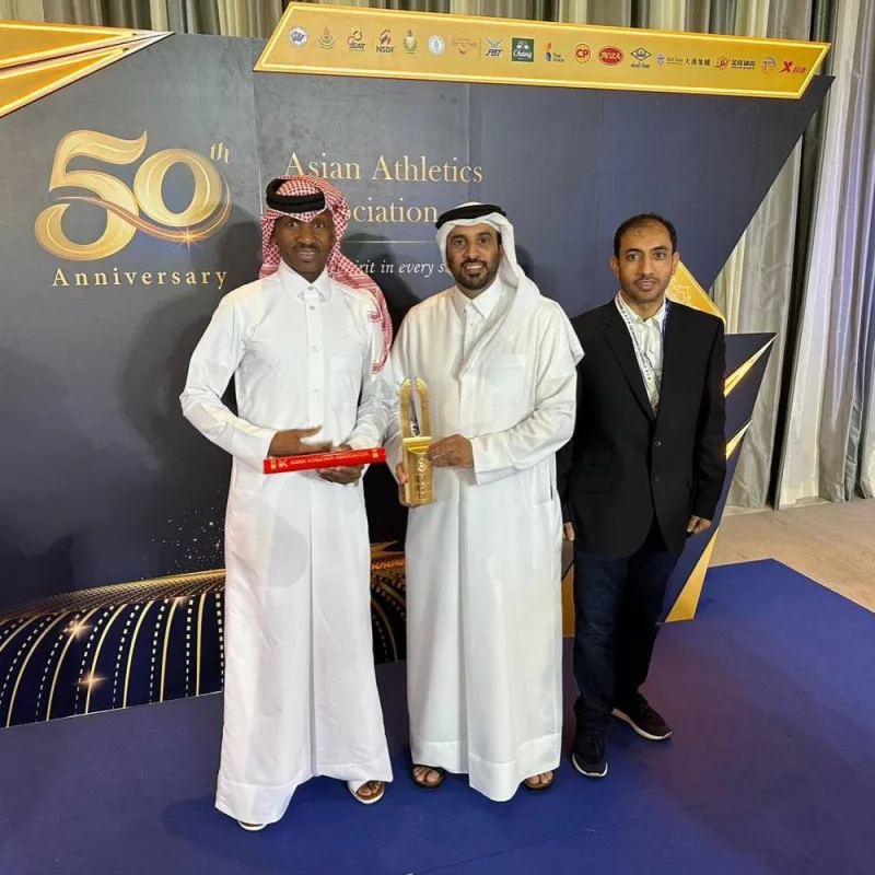 Essa Barshim (left), father of Qatari track and field star Mutaz Barshim, poses with Qatar Athletics Federation president Mohamed Issa al-Fadala after receiving the &#039;Best Asian Athlete&#039; award in Bangkok, Thailand, Monday.