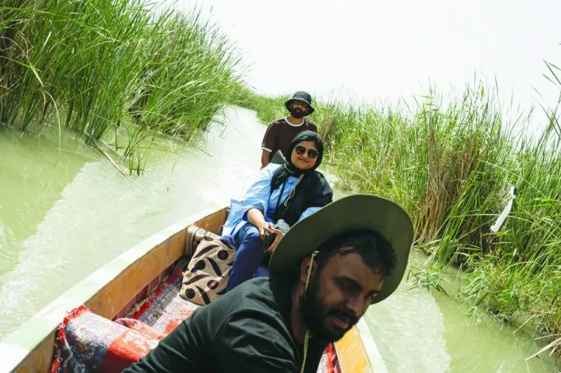 
Anna Nikolaevna, 38, a Russian national, and Jacob Nemec, 29, an American national, walk during a tour in the ancient city of Babylon, Iraq. Right: Lorin and Galton Lenie, French tourists of Sri Lankan descent, go on a tour of the marshes, accompanied by a tour guide, inside a boat locally referred to as the mashhouf, in Nassiriya, Iraq. 