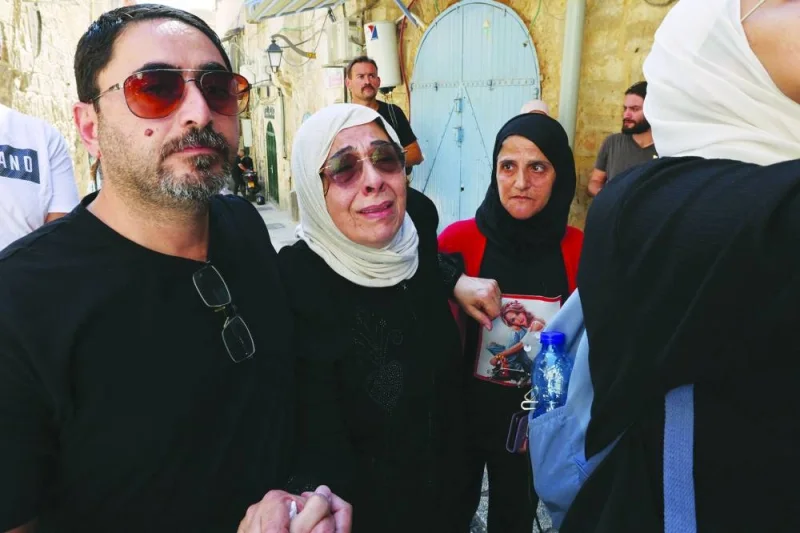 
Nora Sub Laban (centre) is comforted by her son Ahmad during a protest following the eviction of their family from their home in the Muslim Quarter in Jerusalem’s old city to make way for settlers, yesterday. 